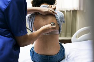 Doctor checking a breathing of a patient