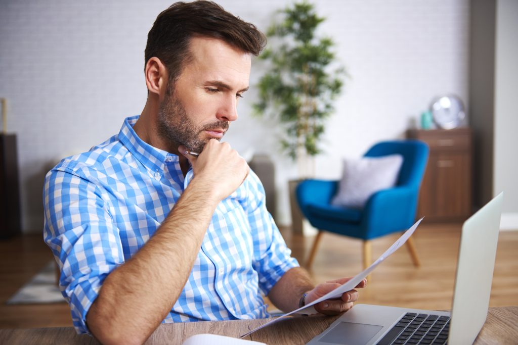 Focused businessman reading important documents at his desk